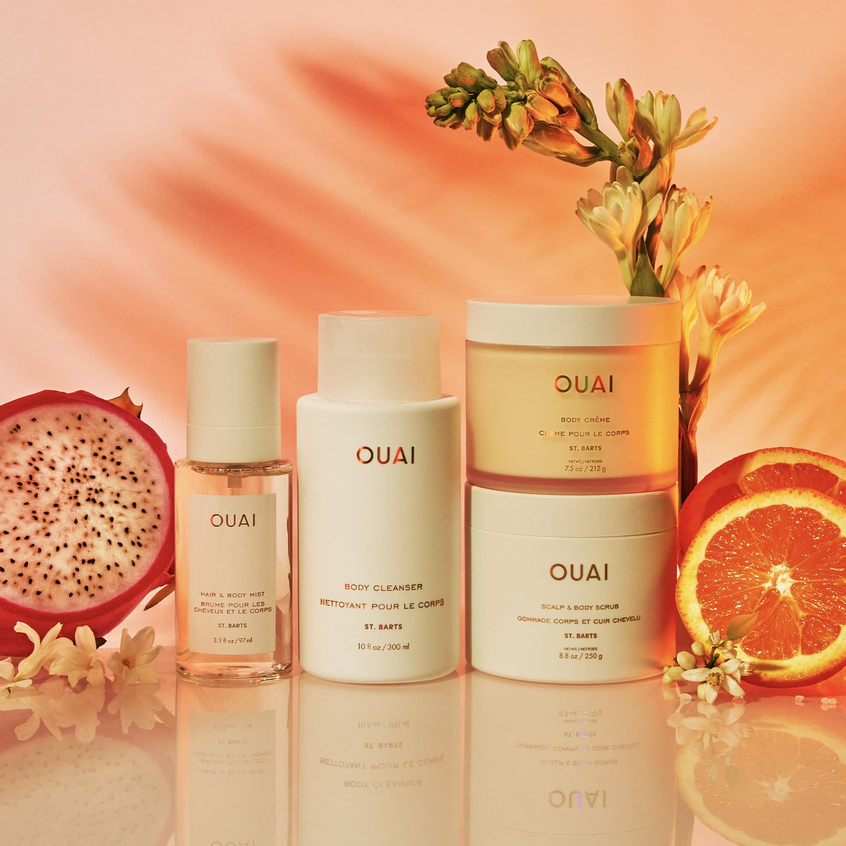 OUAI St. Barts gift set styled in a beach bag evoking tropical, on-the-go fragrance