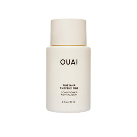 OUAI travel bottle front view showing cleanser benefits and compact size