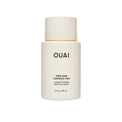 OUAI travel bottle front view showing cleanser benefits and compact size