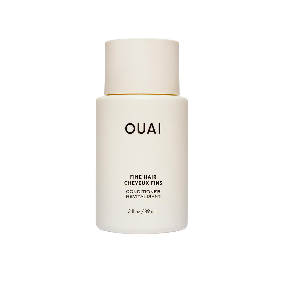 OUAI travel bottle front view showing cleanser benefits and compact size