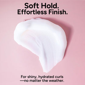 Stylist demo of Ouidad rake and shake application promoting defined curl formation