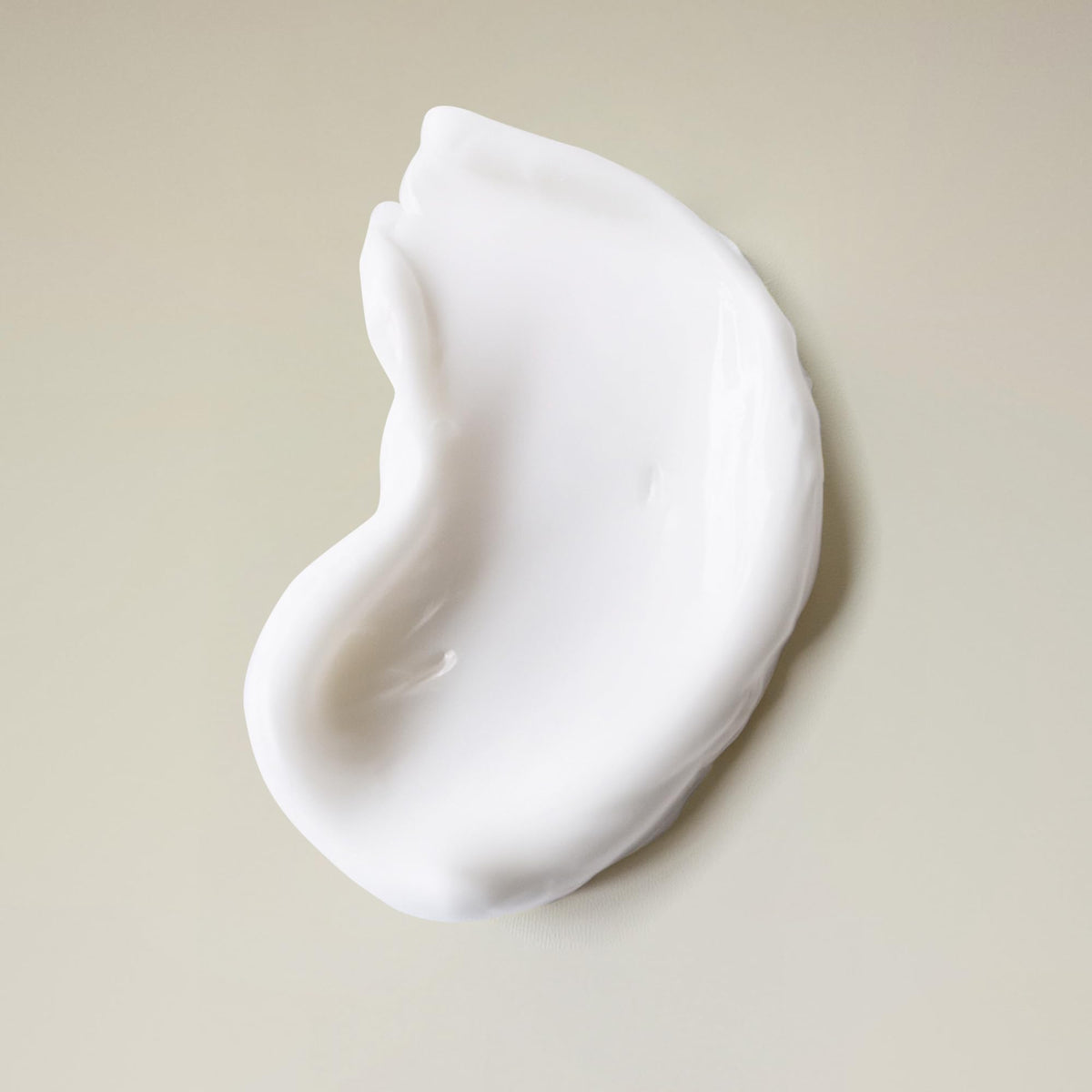Product in shower being applied to loose curls showing cleanse and refresh benefit