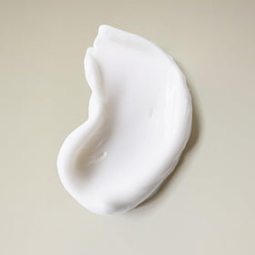 Product in shower being applied to loose curls showing cleanse and refresh benefit