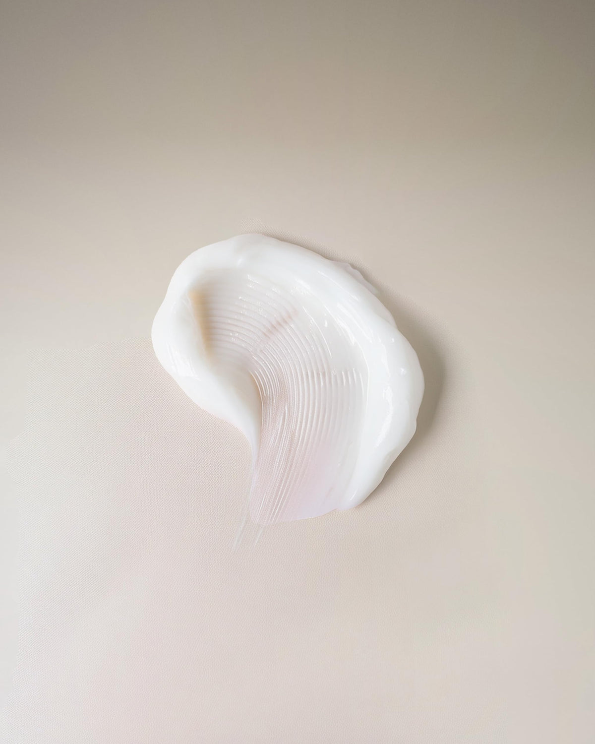 Ouidad cream texture close-up illustrating lightweight, fast-absorbing formula benefit
