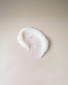 Ouidad cream texture close-up illustrating lightweight, fast-absorbing formula benefit