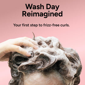 Ouidad salon bottle on shelf reflecting professional-grade curl formulation