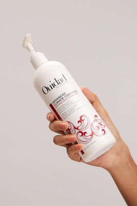 Ouidad size scale next to hand illustrates 16 fl oz volume