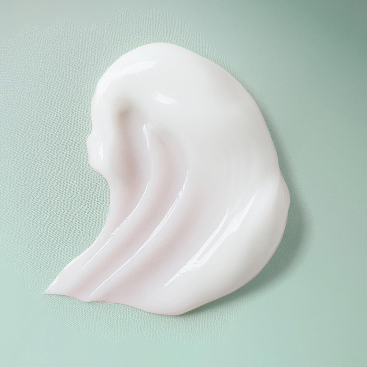 Ouidad styling cream being applied to wet hair demonstrating easy distribution