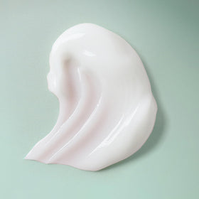 Ouidad styling cream being applied to wet hair demonstrating easy distribution