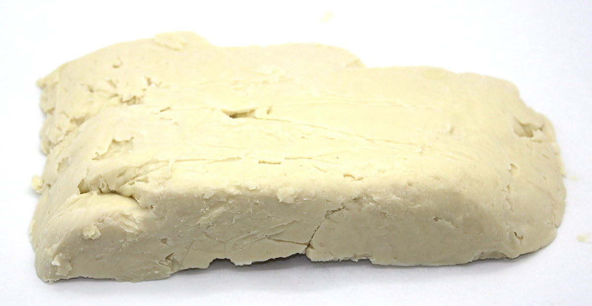 Our Earth's Secrets close-up texture of ivory shea butter revealing creamy consistency