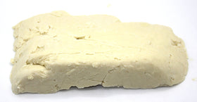 Our Earth's Secrets close-up texture of ivory shea butter revealing creamy consistency