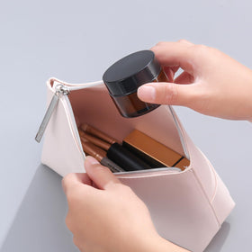 Over News jar beside ruler illustrating 2oz size and space-saving benefit
