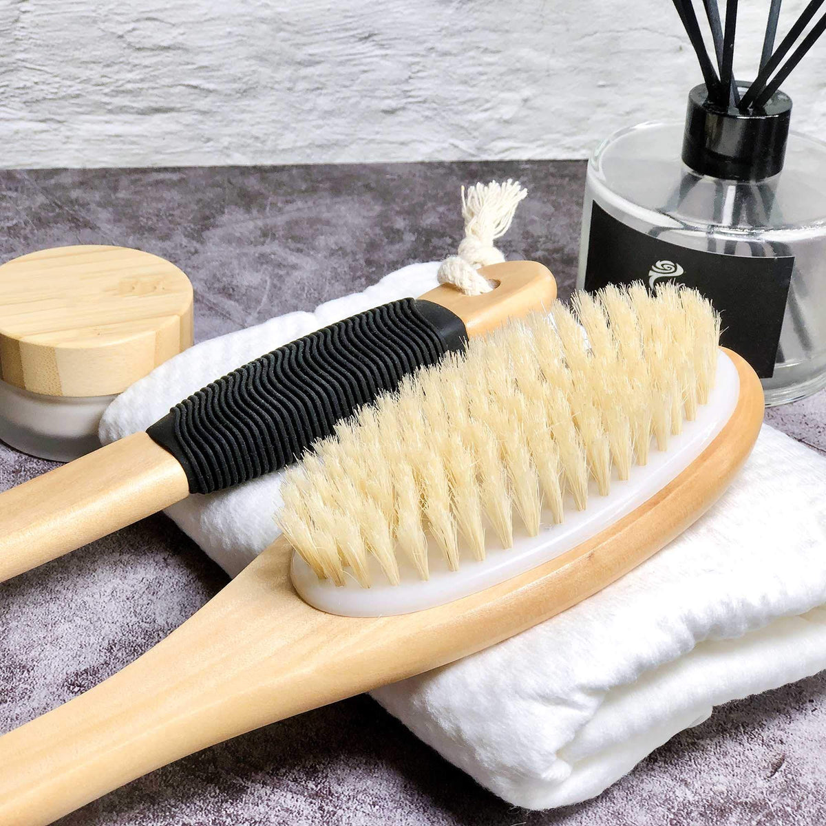 OWIIZI brush next to hand showing length and scale for accessibility
