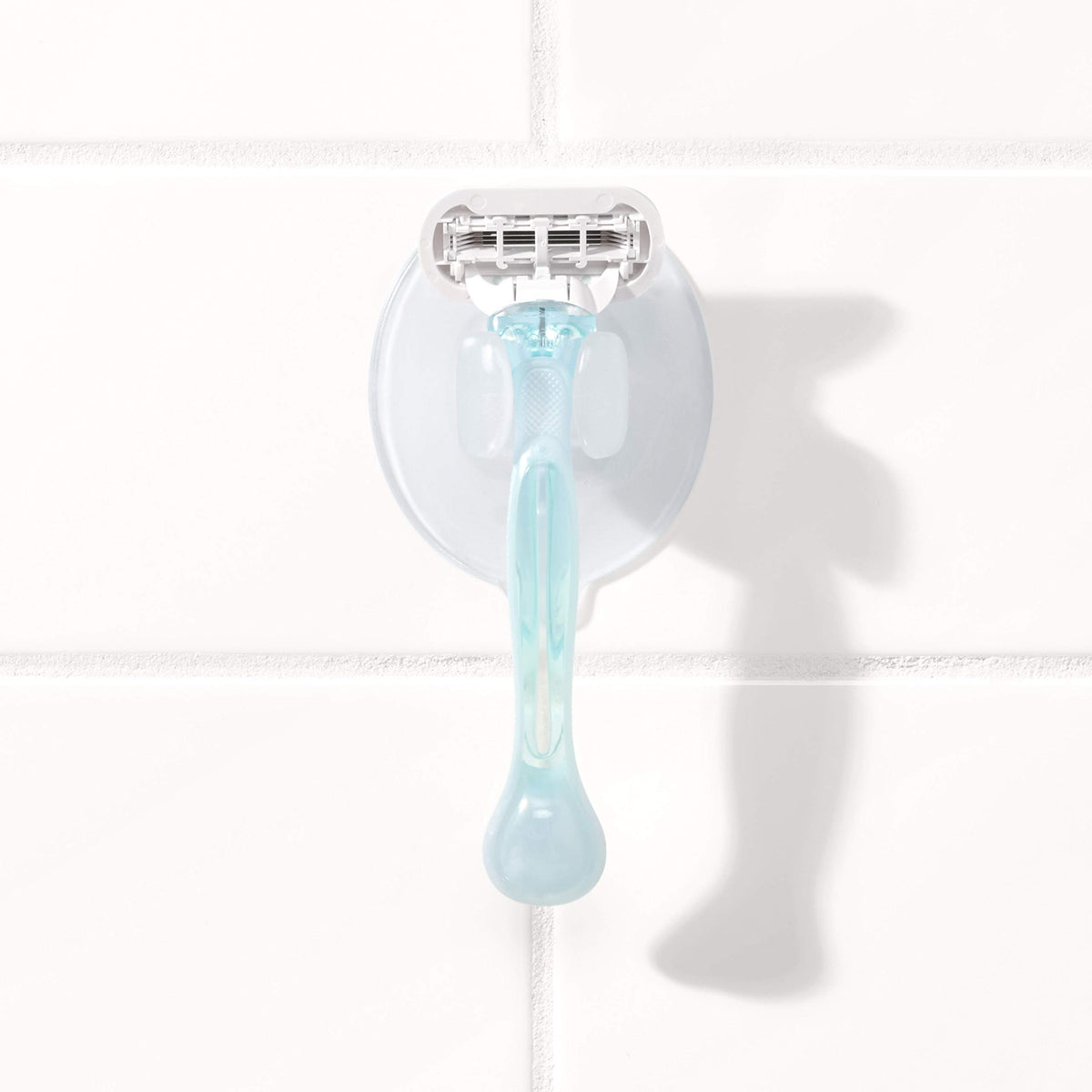 OXO lifestyle shot in shower illustrating space-saving, tidy bathroom
