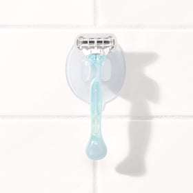 OXO lifestyle shot in shower illustrating space-saving, tidy bathroom