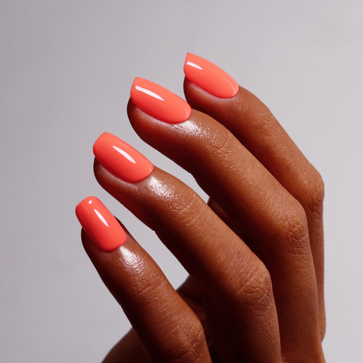 Ozzeal brush applying polish close-up highlighting thin even coats for long-lasting wear