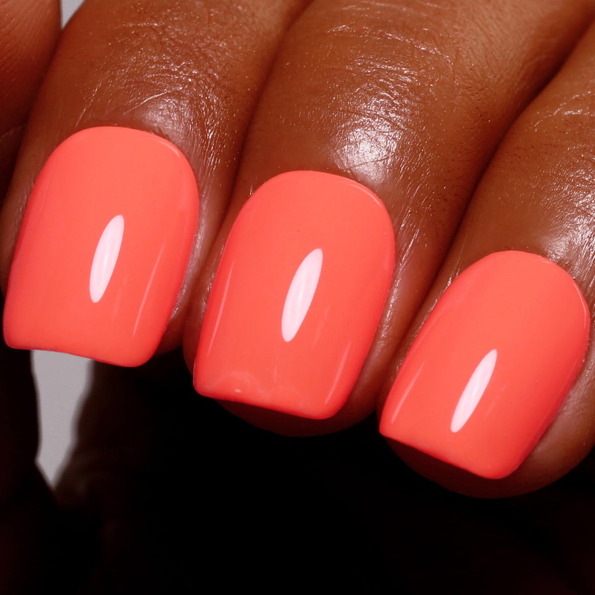 Ozzeal bottle front view showing bright coral orange shade and clear label for instant color recognition