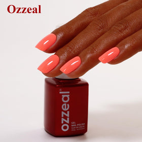 Ozzeal finished manicure on hand in natural light showcasing the coral shade as a fashion accent
