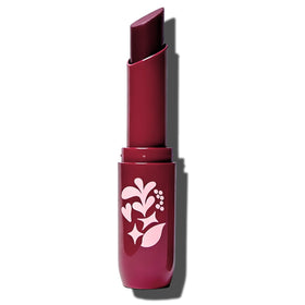 Pacifica lip butter next to coin showing compact travel-ready size and convenience
