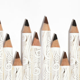 Pacifica Fringe pencil beside coin showing compact travel size