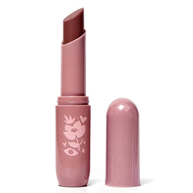 Pacifica lip butter in hand for scale, illustrates compact travel-friendly size