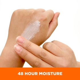Cream texture on fingers from Palmer's showing smooth absorption and deep hydration