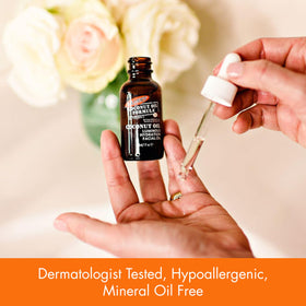 Hand applying Palmer's oil to cheek demonstrating easy absorption and hydrated look