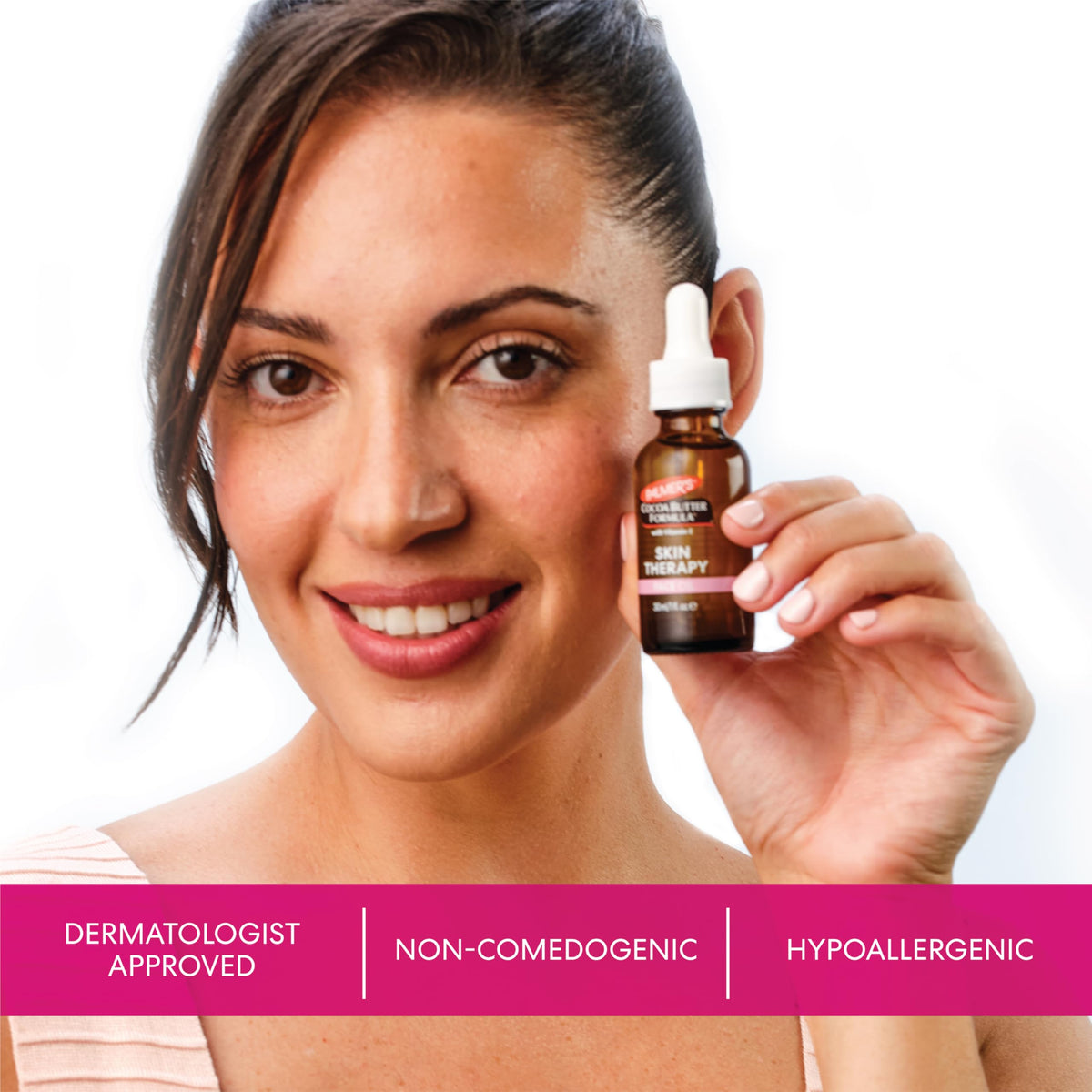 Palmer's face oil beside a hand to show 1-ounce size and portable convenience benefit