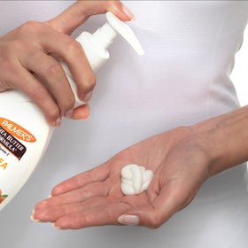 Applying Palmer's lotion to hands to show quick absorption and soothing effect