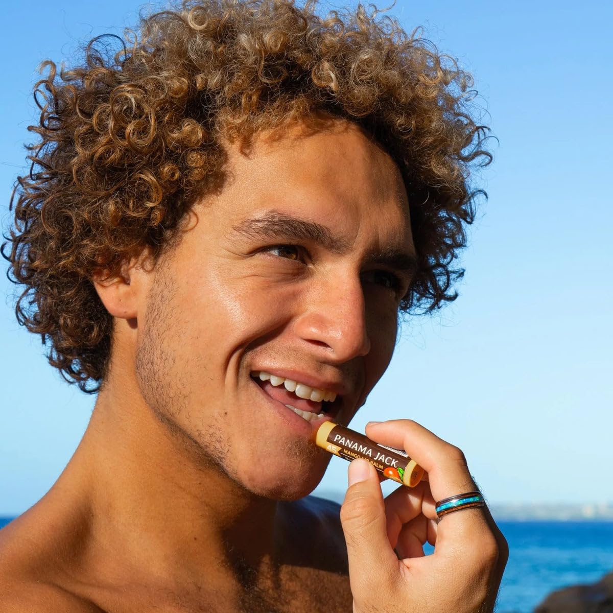Panama Jack lip balm applied at beach providing visible sun protection benefit