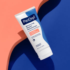PanOxyl PM being smoothed onto skin illustrating soothing and moisturizing benefits