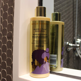 Pantene Gold Series stylist applying shampoo showing professional technique and results