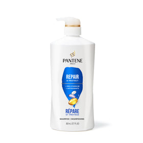 Pantene bottle next to everyday objects to show 27.7 fl oz scale