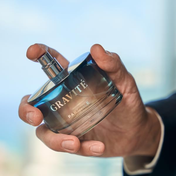 Particle Gravité held in hand for size comparison, demonstrates travel-friendly 3.38 fl oz