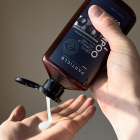 Particle 400 mL bottle next to a hand for size comparison