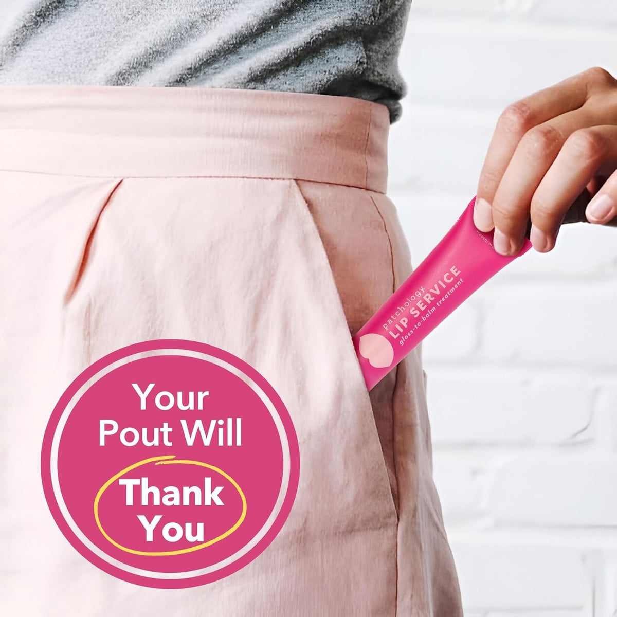Patchology gloss in a handbag next to a mirror for on-the-go hydration benefit