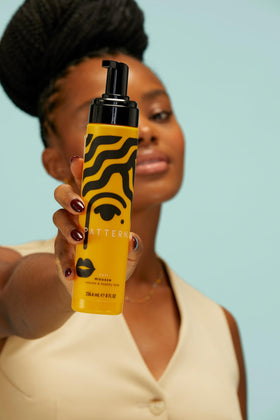 PATTERN curl mousse in-hand application showing product dispersion and effortless styling control