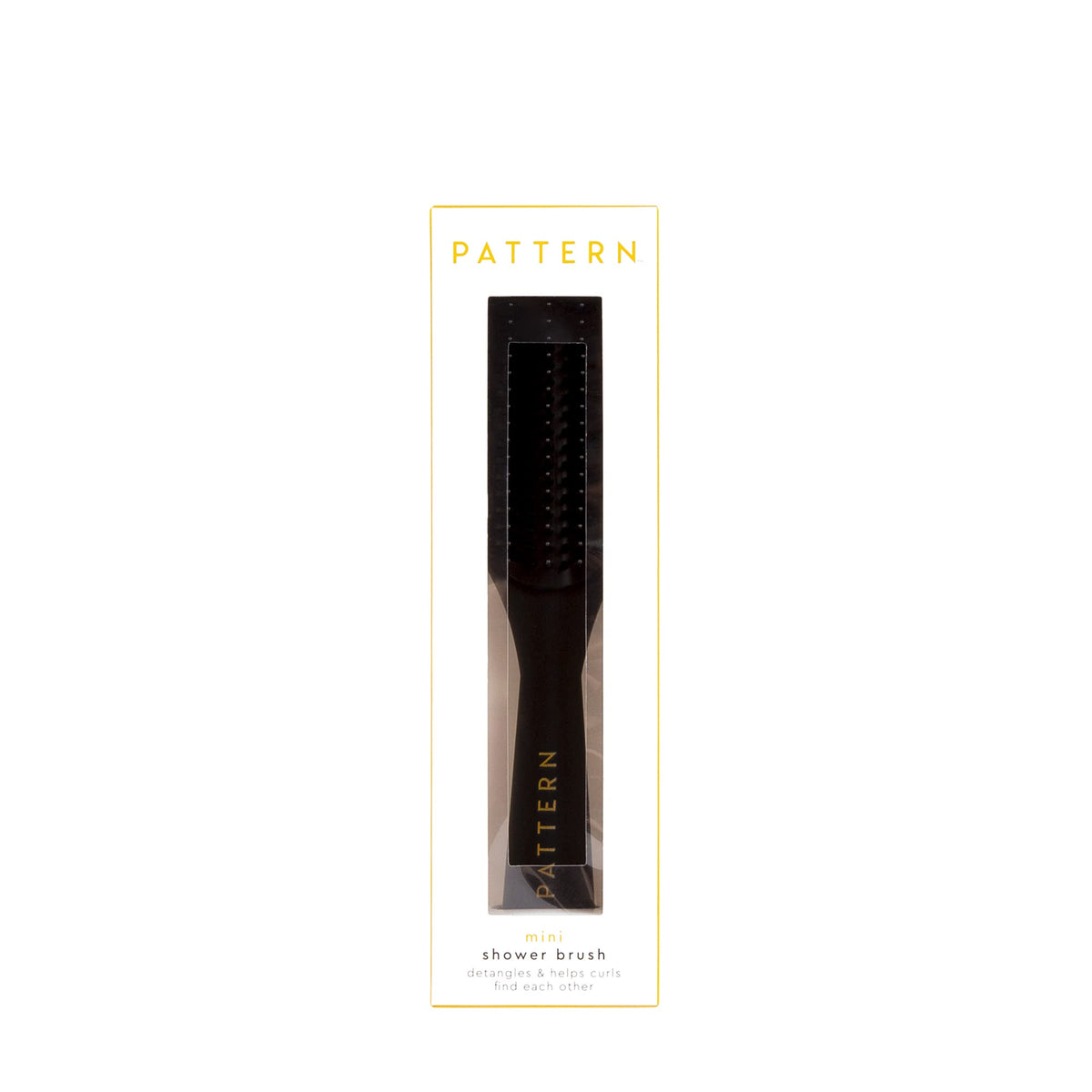 PATTERN brush next to hand to show travel-friendly size and convenient portability