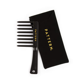 PATTERN mini comb held in hand to show scale and travel-friendly convenience