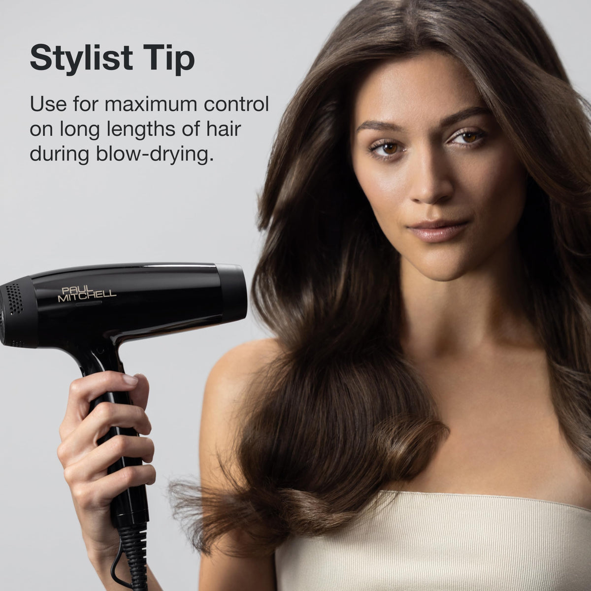 Paul Mitchell brush in use while blow-drying long hair for smoother, lifted results