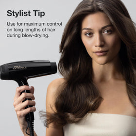 Paul Mitchell brush in use while blow-drying long hair for smoother, lifted results