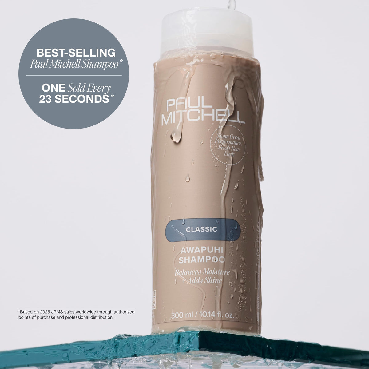 33.8 fl oz Paul Mitchell bottle beside a hand to show generous size and value