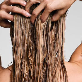 Paul Mitchell being applied in shower, showing gentle use for sensitive scalp