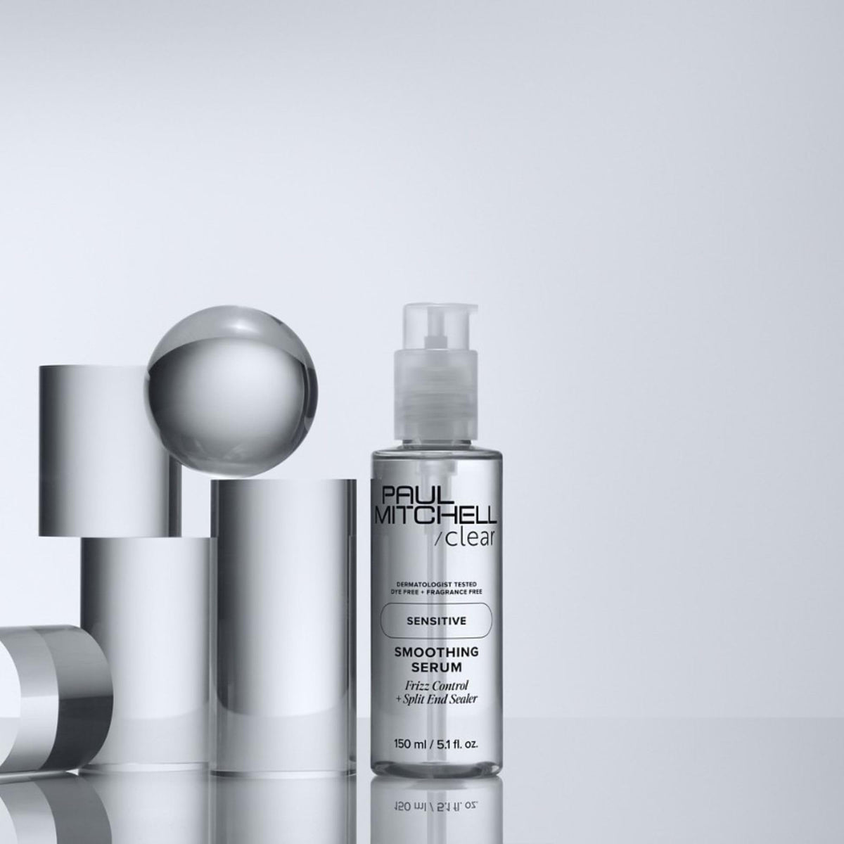 Paul Mitchell applying serum to damp hair for faster blow‑drying