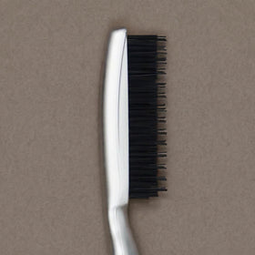 Paul Mitchell brush on a styling dresser next to clips showing ready-to-use convenience