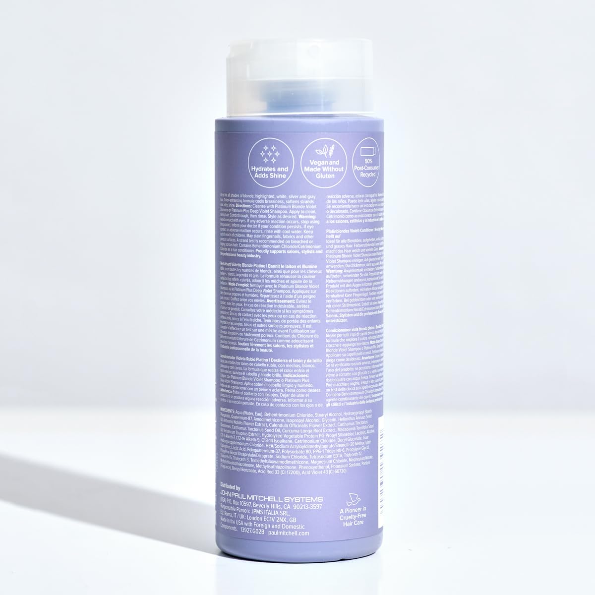 Stylist applying Paul Mitchell conditioner in salon showing professional results