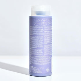 Stylist applying Paul Mitchell conditioner in salon showing professional results