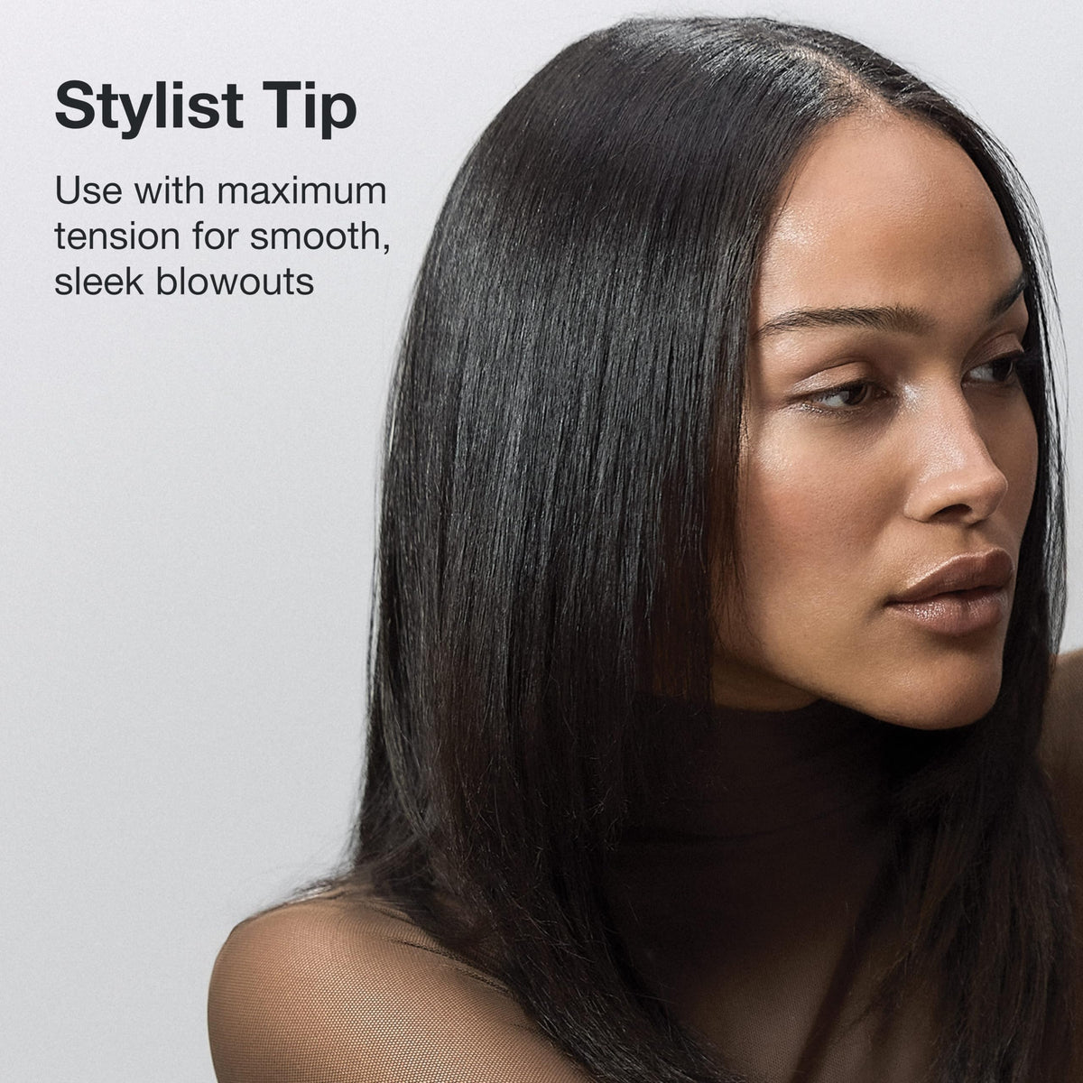 Paul Mitchell Pro Tools brush being used on damp hair to define curls before diffusing