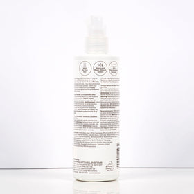 Paul Mitchell stylist applying root boost in salon for professional volumizing results