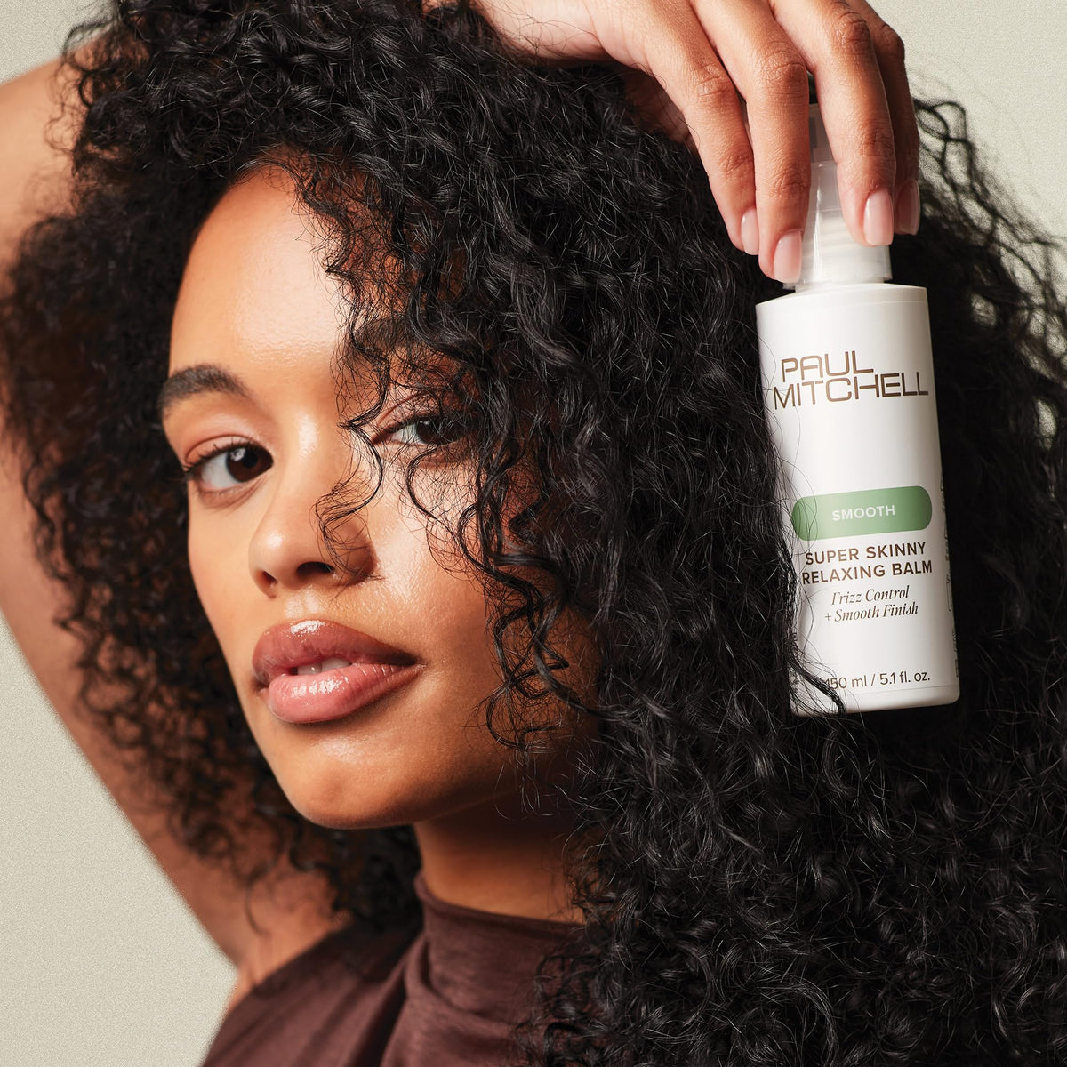 Paul Mitchell bottle next to hand showing 5.1 fl oz size reference